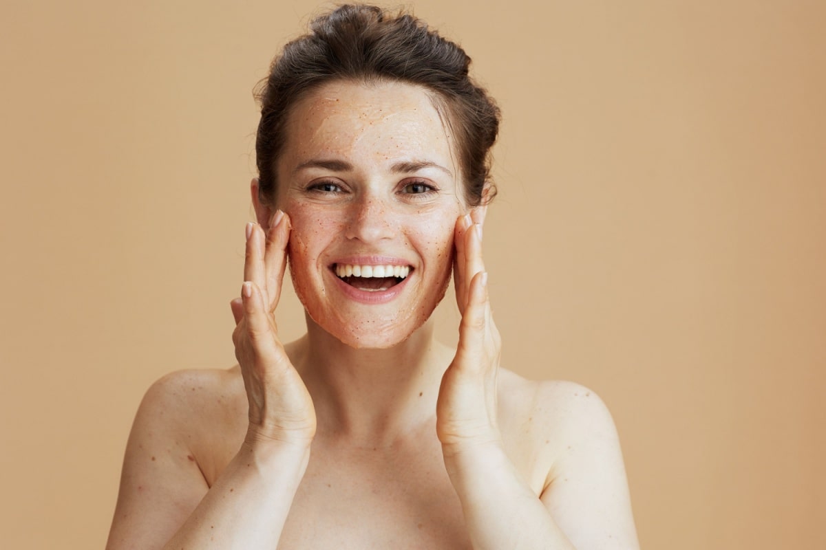 a woman exfoliating her face